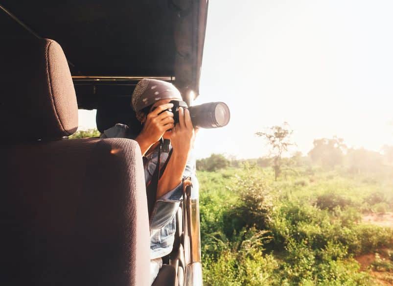 A tourist taking pictures during a safari